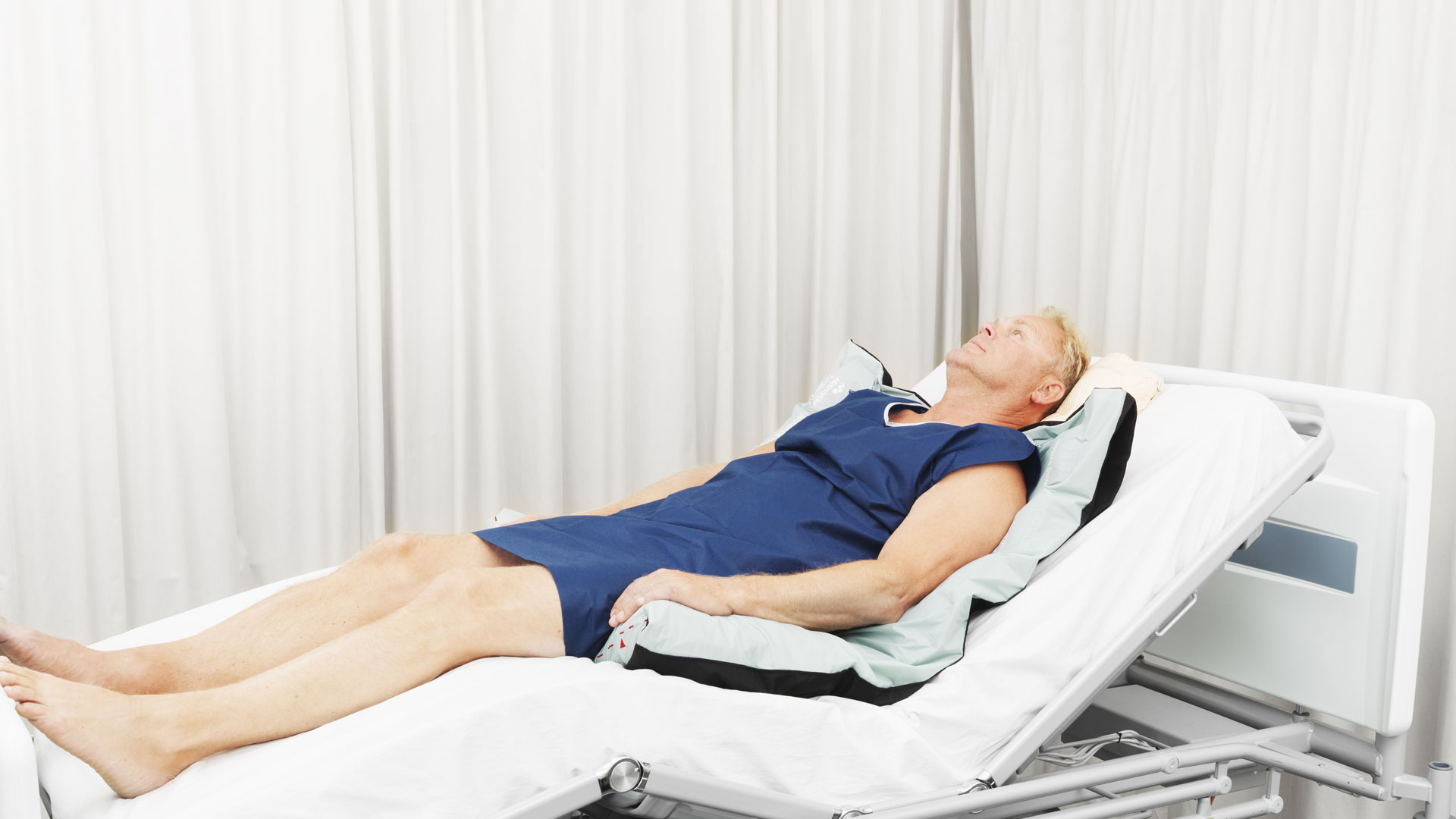 Patient lying on Mölnlycke Turning and Positioning system