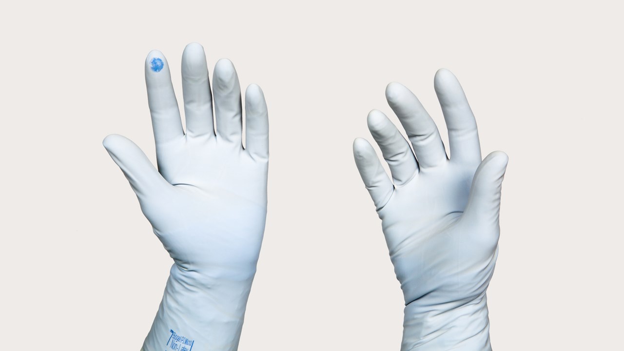 two hands gloved in Puncture Indication System gloves